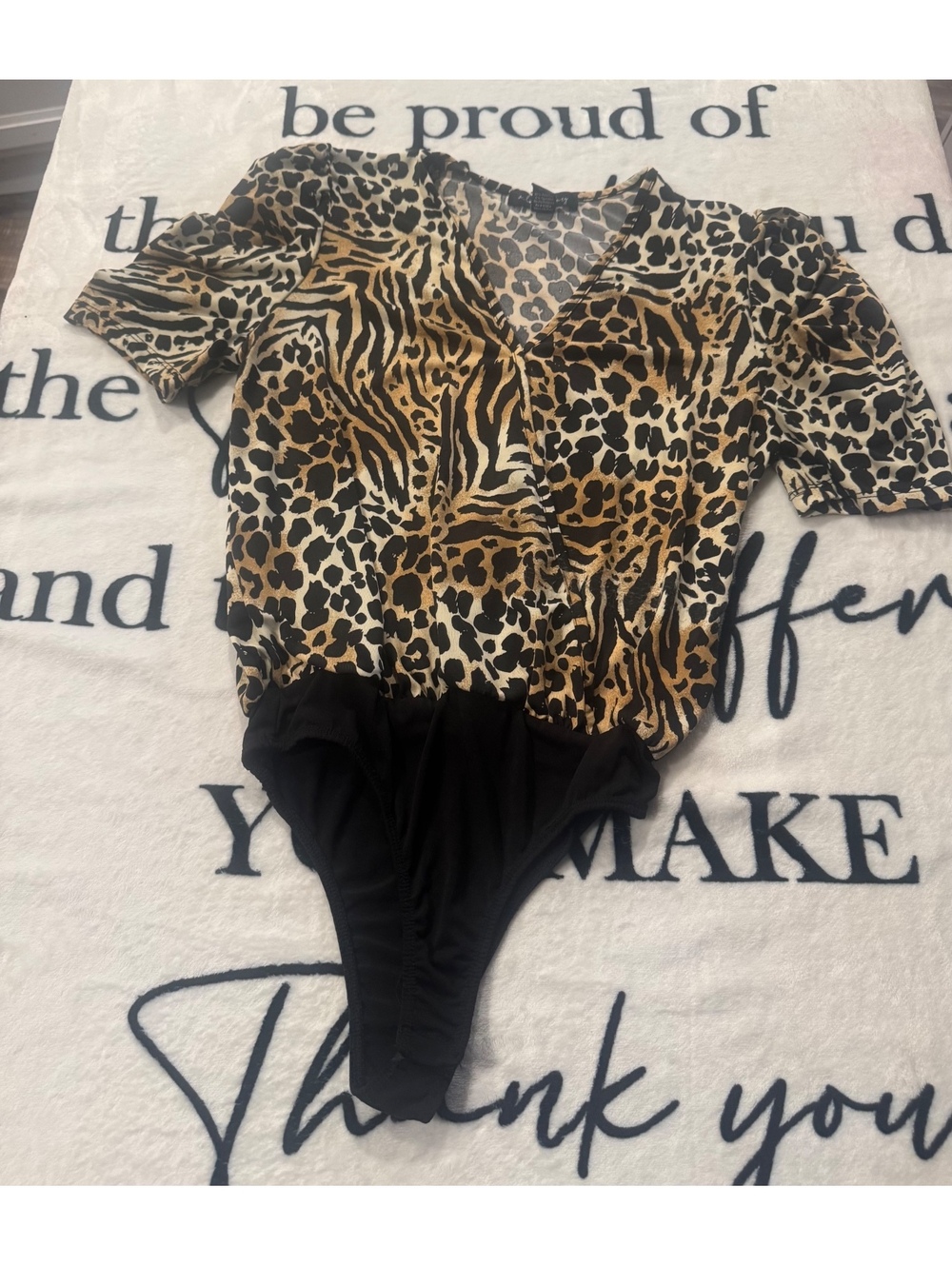 Modern animal-print bodysuit with a wrap neckline by "a... love story," size S